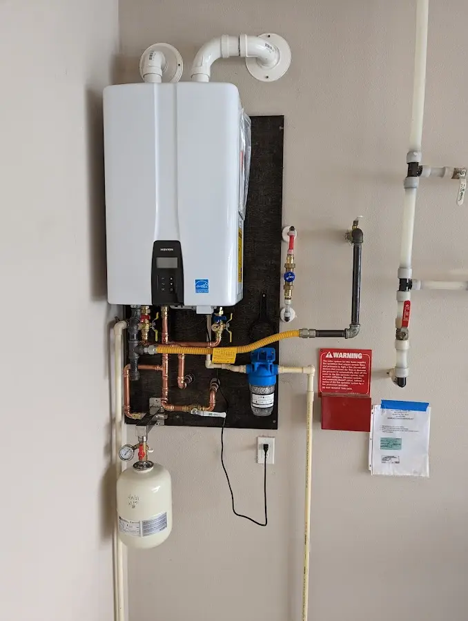 Professional plumber installing copper piping in a Beloit home